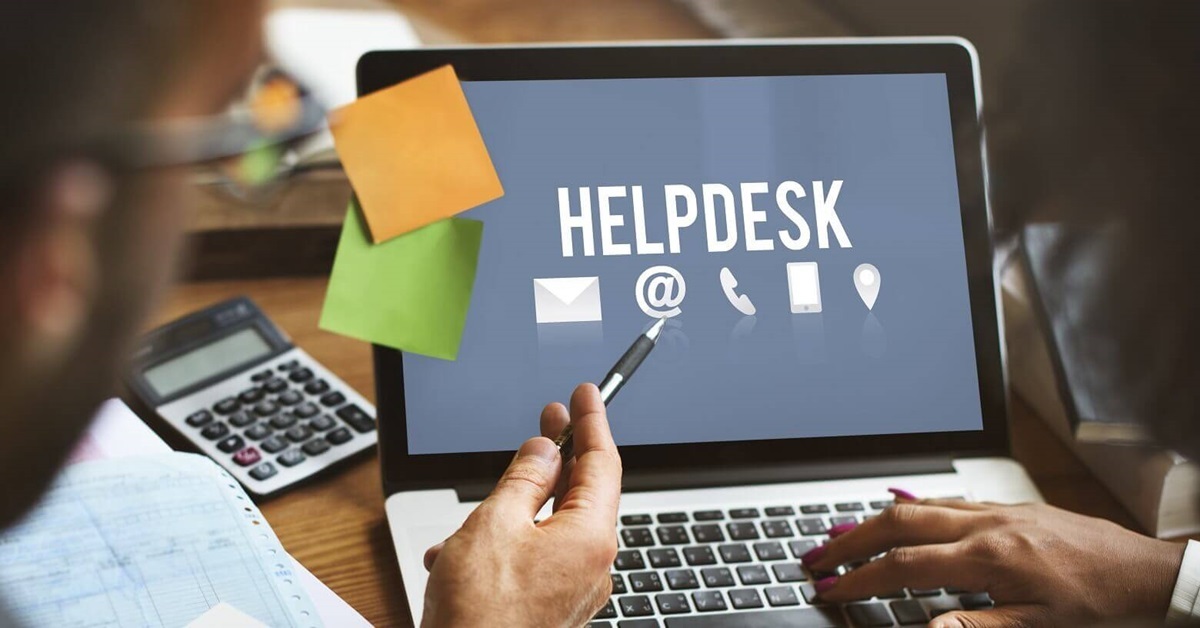 people looking at a helpdesk screen on a laptop
