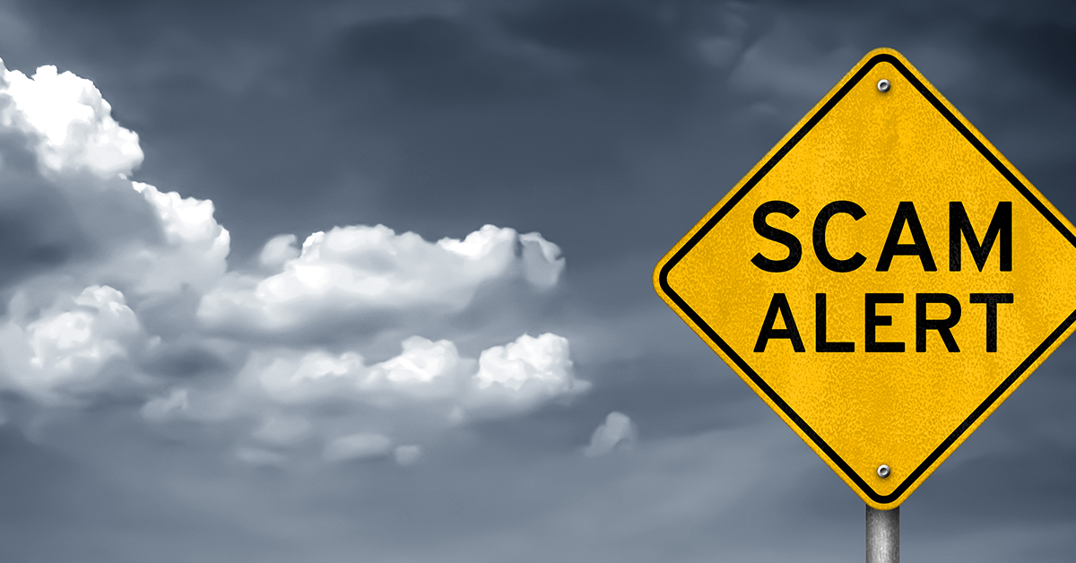 scam alert sign with threatening weather behind